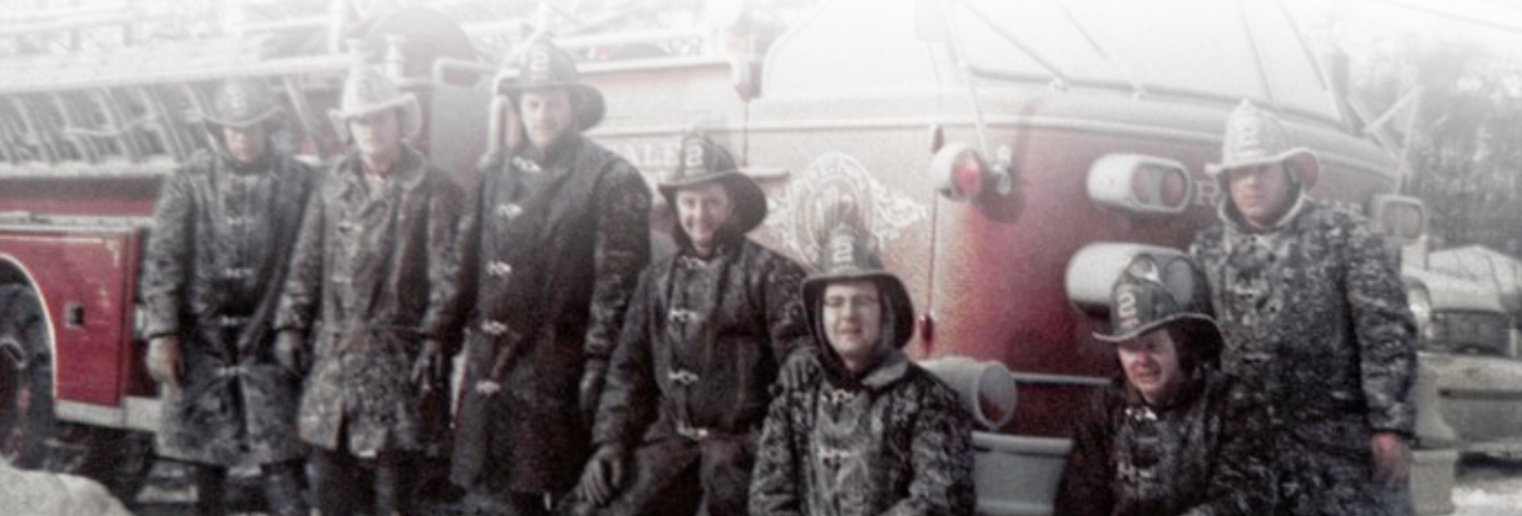 Men in front of old fire truck